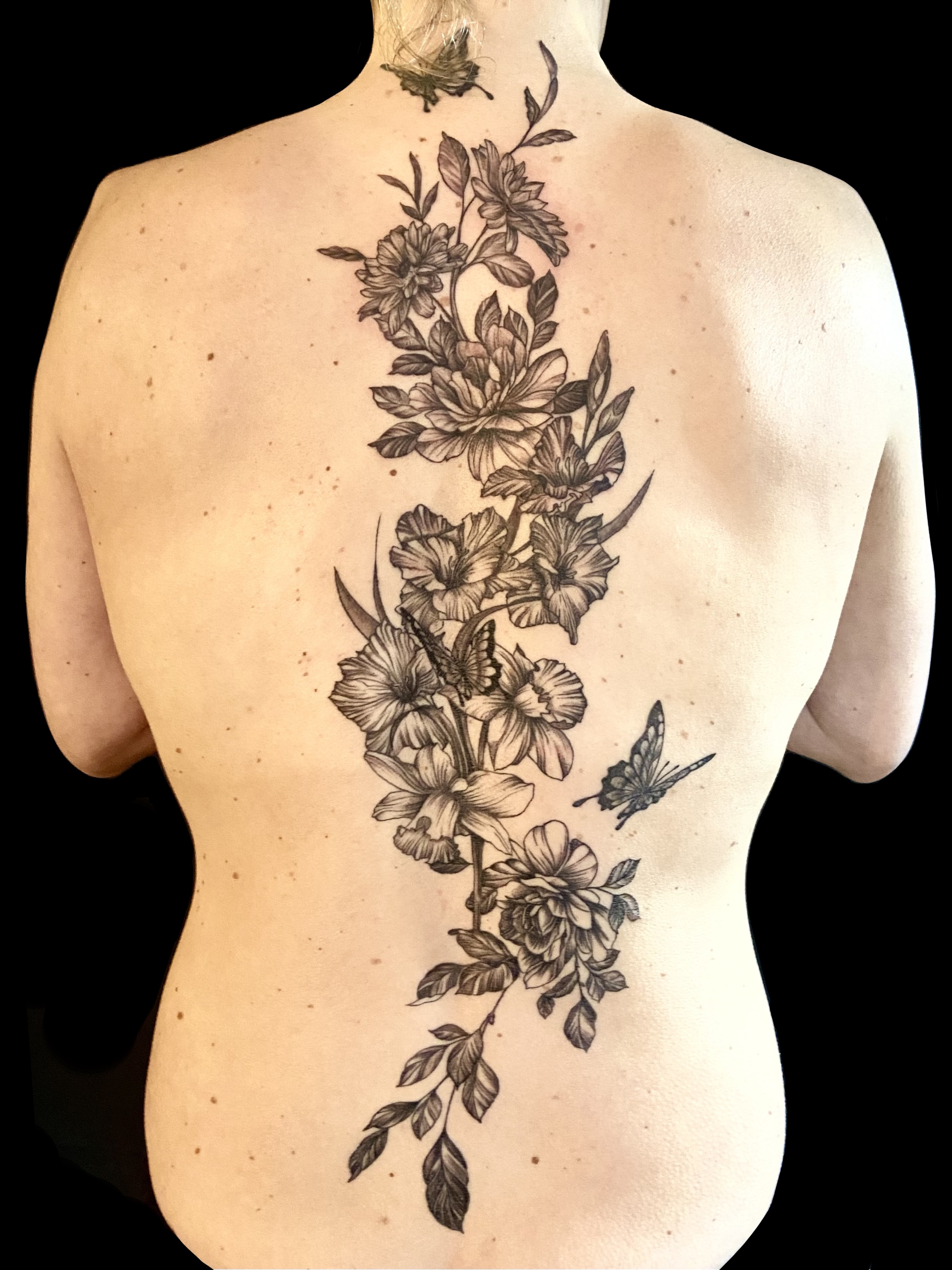 Fine line floral backpiece tattoo gallery cover by Embodiment of Ink